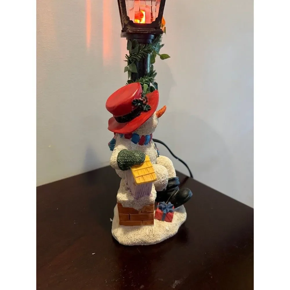 Snowman with flickering street lamp